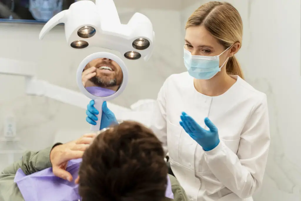 Dentist examining patient during dental consultation and discussing treatment options in a modern dental clinic.