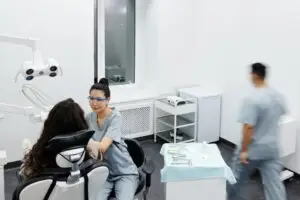 Dentist providing dental treatment to a patient in a modern clinic, showing professional dental care in Great Neck, NY.